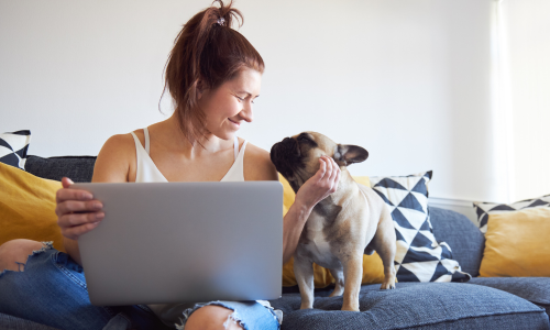 Woman on laptop with dog